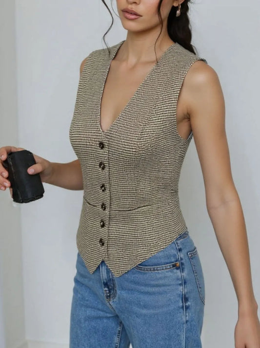Woman wearing a plaid button down vest styled with jeans, highlighting the clean, classic design and lined interior for comfort.