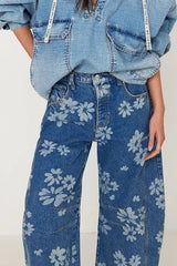 A model wearing Flower Print Wide Leg Pants made of denim with a floral pattern, styled with a denim top.