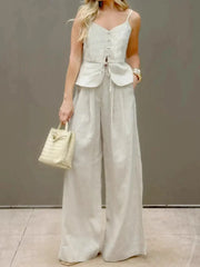 Lightweight cotton two-piece set featuring a V-neck cami and relaxed fit pants, accessorized with a chic bag.