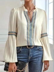 Notched Textured Balloon Sleeve Blouse with pleated fabric, embroidered trim, and feminine silhouette paired with jeans for an elegant look.