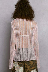 Back view of a POL Openwork Round Neck Knit Cover Up with an open-knit pattern, pink color, worn by a person with curly hair.