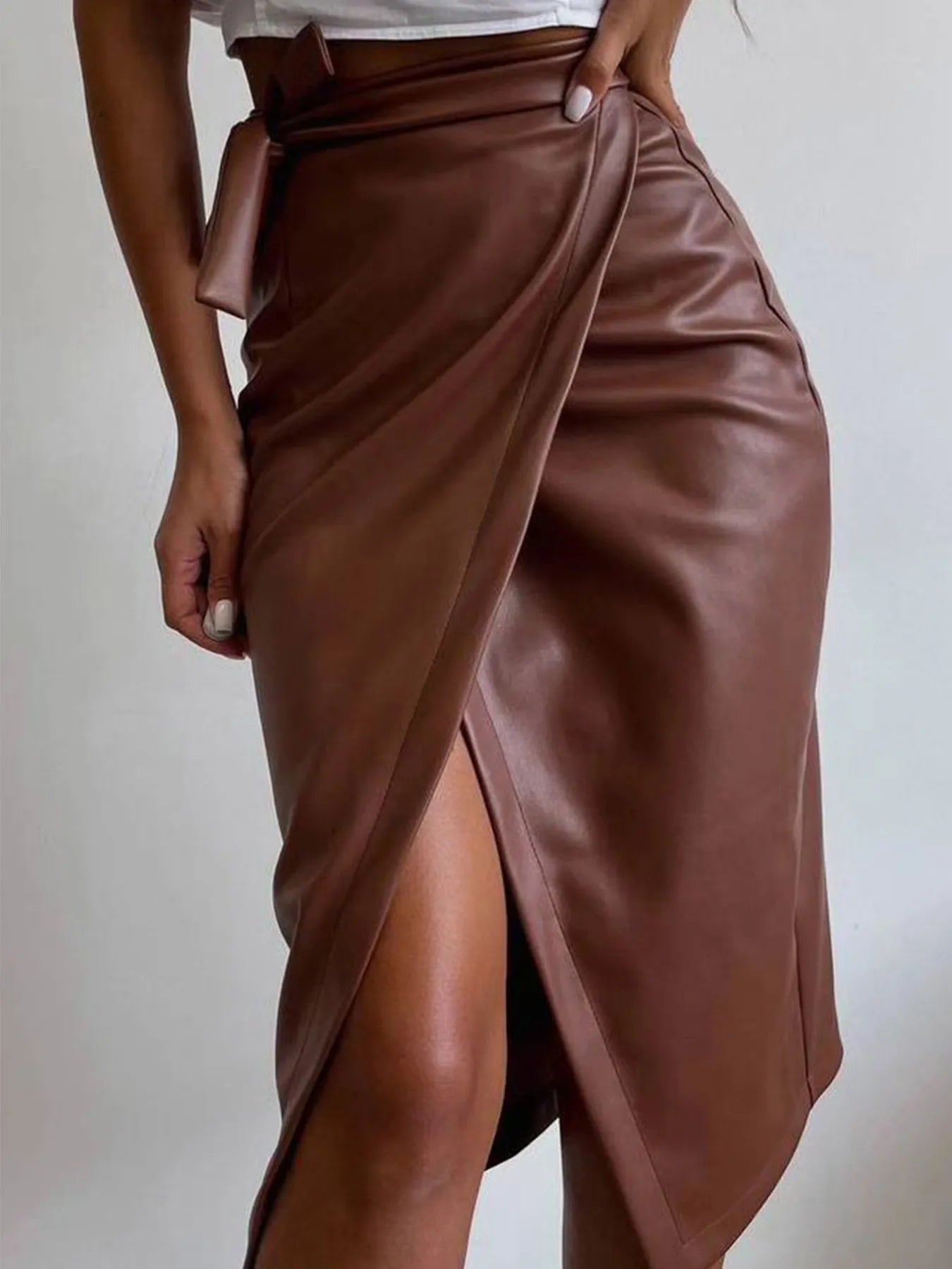 Fashionable Slit Leather Midi Skirt with front slit, featuring chic faux leather finish for sophisticated style.