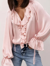 Ruffle Trim Satin Flounce Sleeve Blouse in pink with tie-neck detail and ruffled front, styled with denim for a day-to-night look.