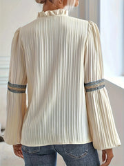Back view of cream-colored Notched Textured Balloon Sleeve Blouse with pleats and embroidered trim.