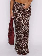 Woman wearing chic leopard print maxi skirt, holding a burgundy purse, perfect for glam or casual outfits.