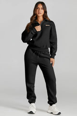 Woman wearing a black Quarter Zip Top and Drawstring Pants Active Set, ideal for casual wear and light activities.