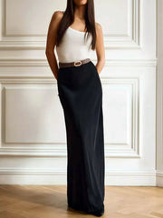 Woman wearing a high-waisted maxi skirt in black, featuring a basic style, not lined, made from 95% polyester and 5% spandex.