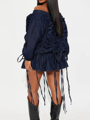 Model showcasing Off-Shoulder Ruched Denim Dress with ruffled details and drawstring adjustments.