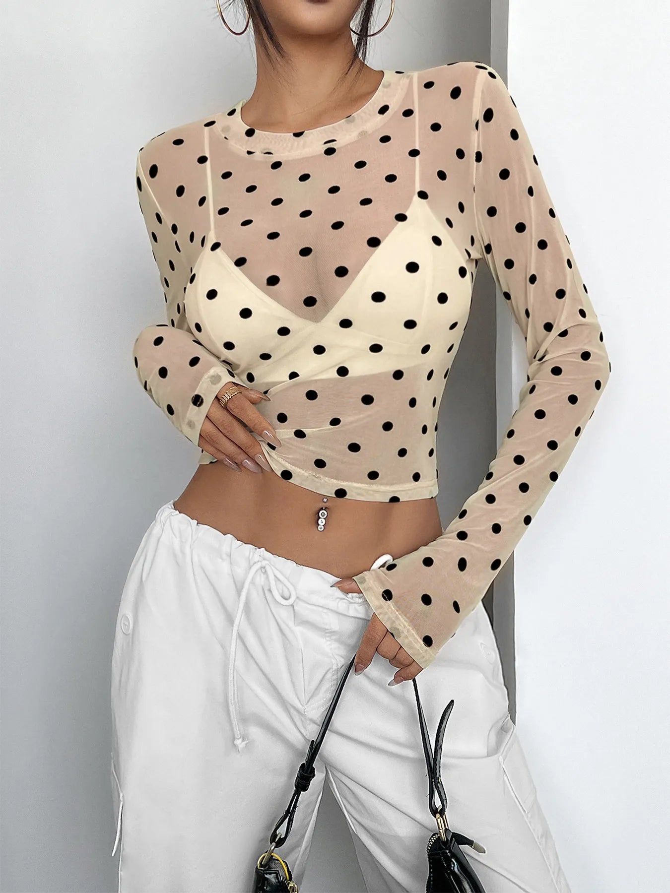 Polka Dot Mesh Long Sleeve Crop Top with black polka dots over soft mesh, chic style ideal for layering or wearing on its own.