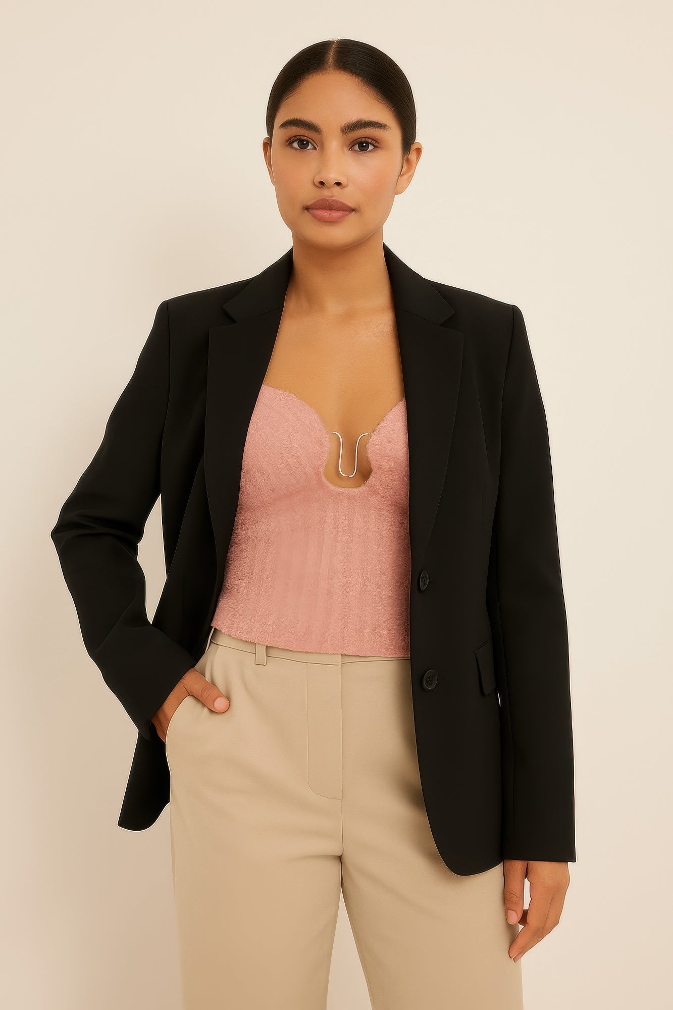 Model wearing chic knit tube top with blazer, showcasing stylish and flattering fit.