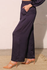 Side view of Modern Satin Pocket Pants in lustrous hammered satin with functional pockets, illustrating chic and relaxed silhouette.