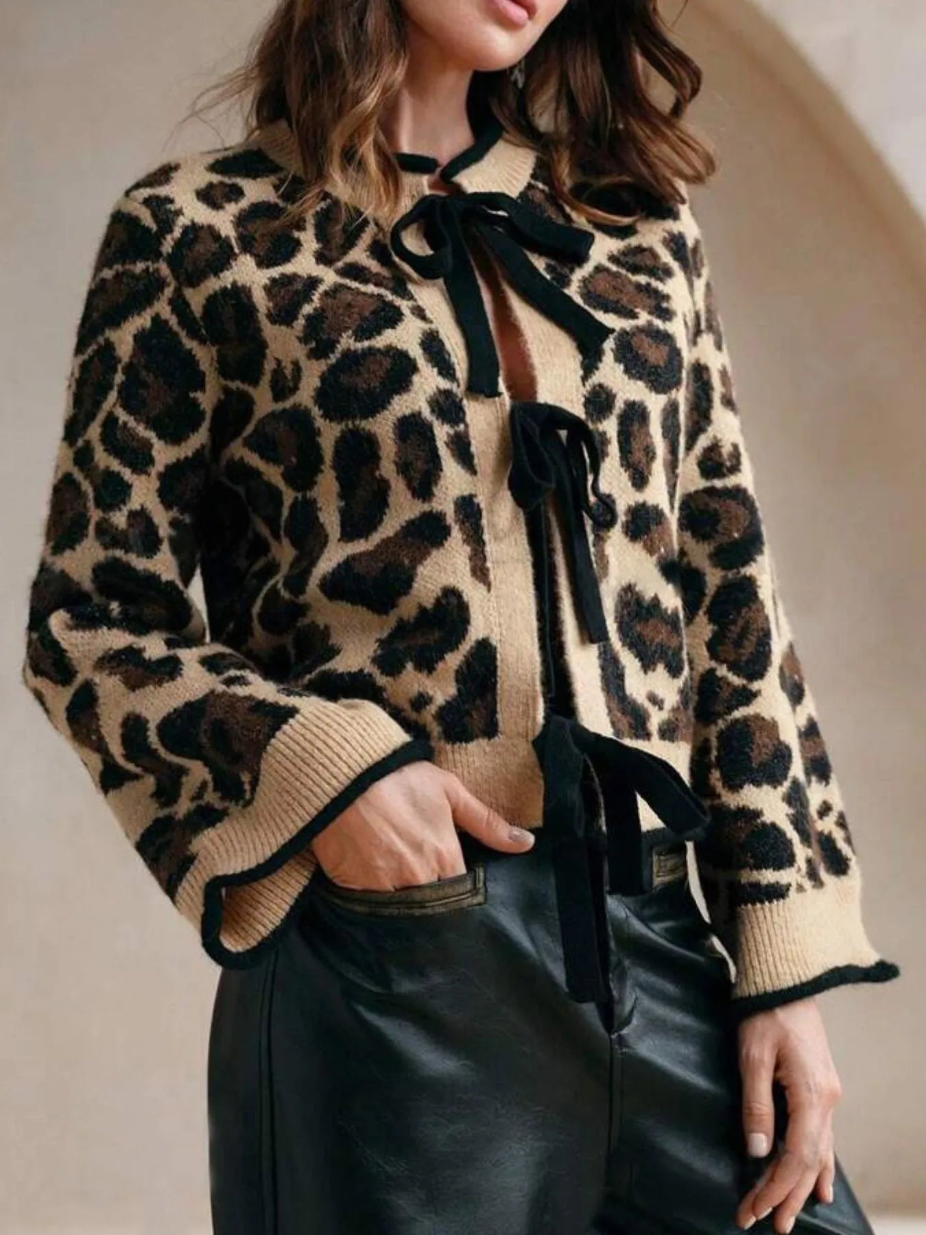 Leopard Print Bow-Tie Front Cropped Cardigan with lace-up detail, perfect for layering and adding a stylish twist to any outfit.