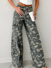 Woman wearing Camo Print Wide Leg Cargo Jeans, featuring a high-rise waist and utility pockets, perfect for street-style fashion.