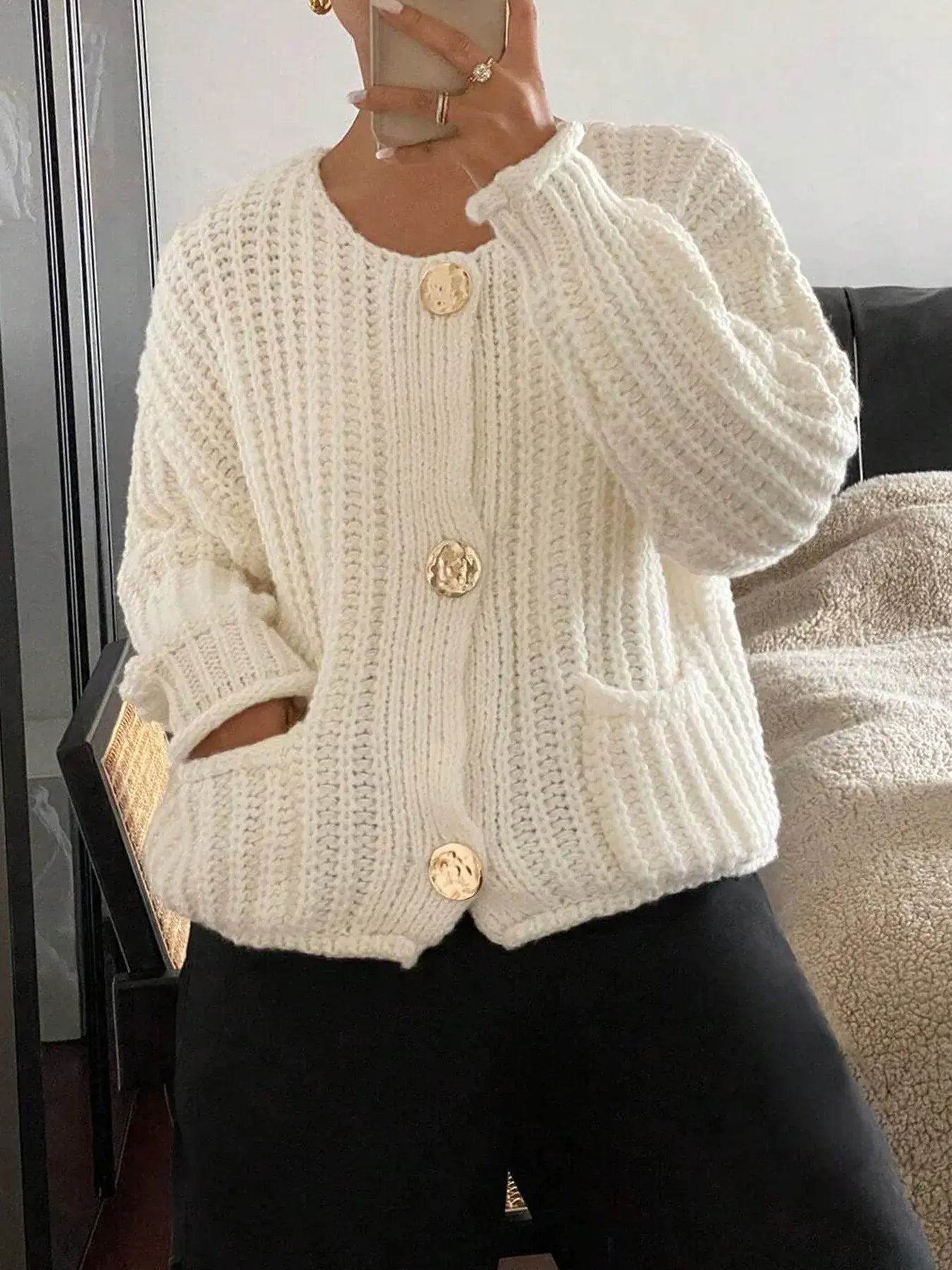 Cozy button-front knit cardigan with pockets, perfect for layering. Features classic design in white, ideal for casual or cozy days.