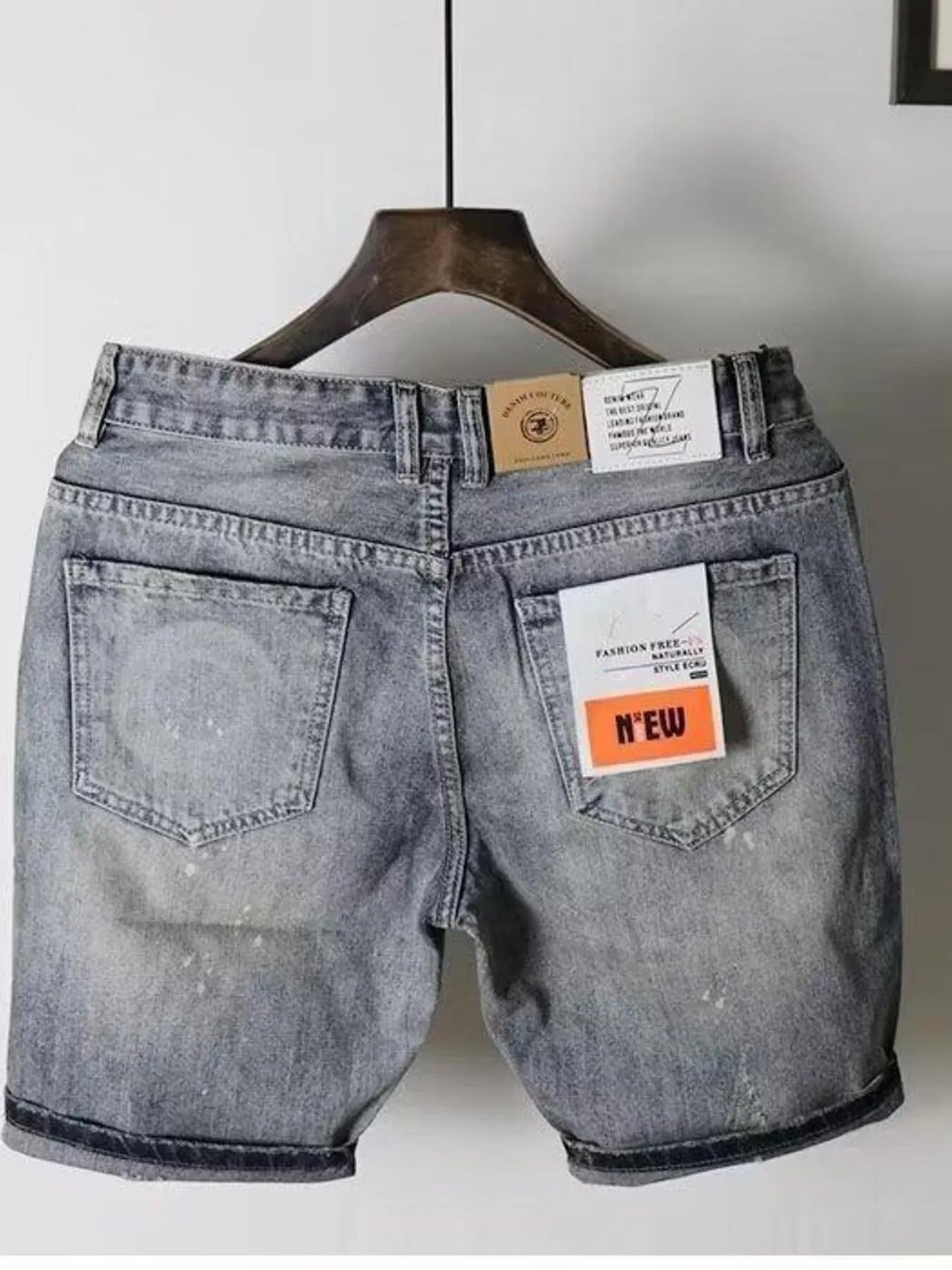 Men's pocketed denim shorts in a light wash with tags displayed, showing back view and slight stretch feature.