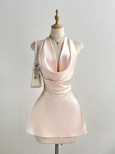 Satin Backless Halter Neck Dress in soft pink with ruched detailing on a mannequin, showcasing its elegant design.