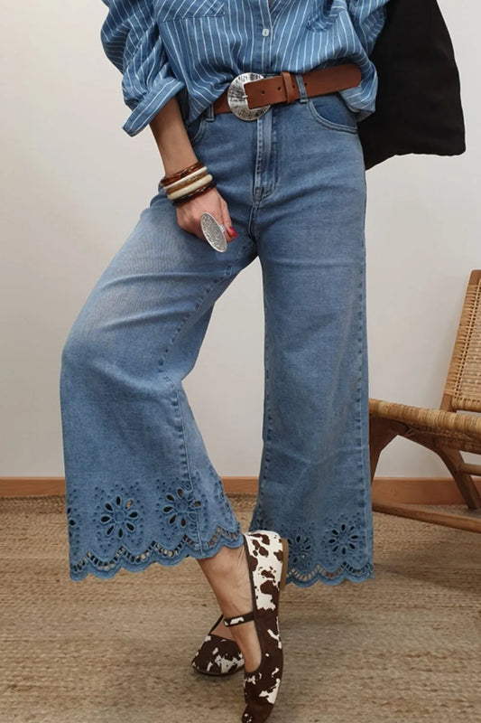 Model wearing lace detail cropped wide leg jeans with a blue shirt and stylish shoes, showcasing a trendy outfit.