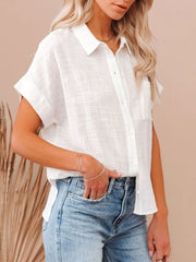 Model wearing a Cotton Button Up Short Sleeve Shirt with a relaxed fit and buttoned details.