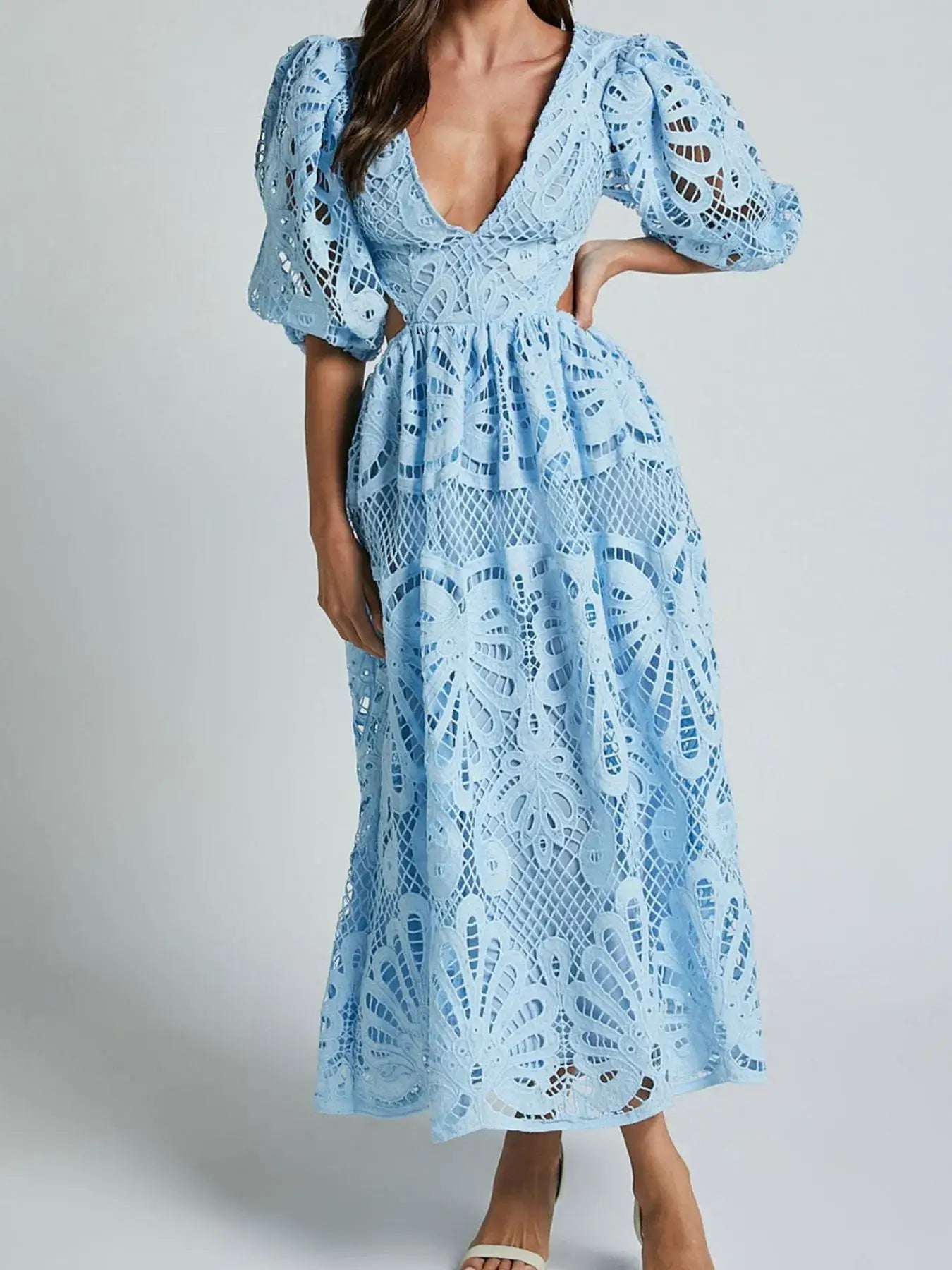 Elegant blue lace crochet dress with cutout back and V-neckline, perfect for evening occasions and showcasing intricate detailing.