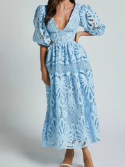 Elegant blue lace crochet dress with cutout back and V-neckline, perfect for evening occasions and showcasing intricate detailing.