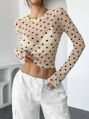 Woman wearing Polka Dot Mesh Long Sleeve Crop Top in modern interior