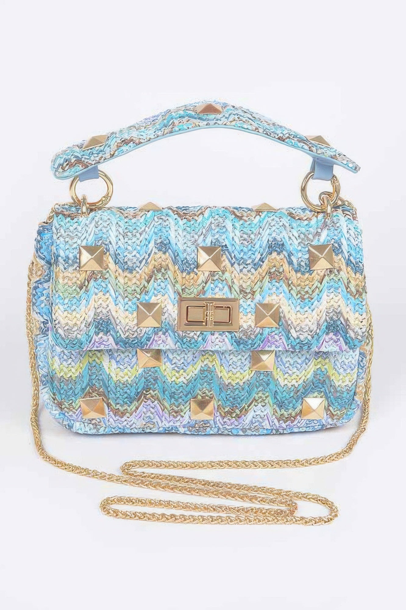 Faux Straw Flap Top Handle Bag featuring a colorful woven design and golden studs for a stylish accent.