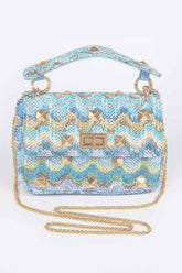 Faux Straw Flap Top Handle Bag featuring a colorful woven design and golden studs for a stylish accent.