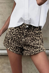 Model wearing leopard print shorts with pockets, paired with a white top. Casual, breathable cotton, perfect for summer styling.