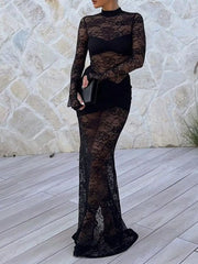 Woman wearing Lace Sheer Mock Neck Long Sleeve Maxi Dress against stone wall backdrop