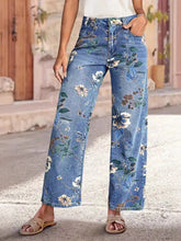 Floral Print Wide Leg Jeans displayed on a model, featuring a vibrant floral pattern and a pocketed design.