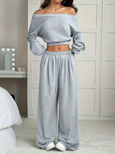Full Size Crop Top & Wide Leg Pants Set worn by a model, featuring a gray off-shoulder crop top and wide leg pants.