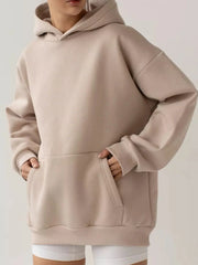 Taupe kangaroo pocket long sleeve hoodie with a hood, shown on a model, highlighting its cozy, stylish and functional design.