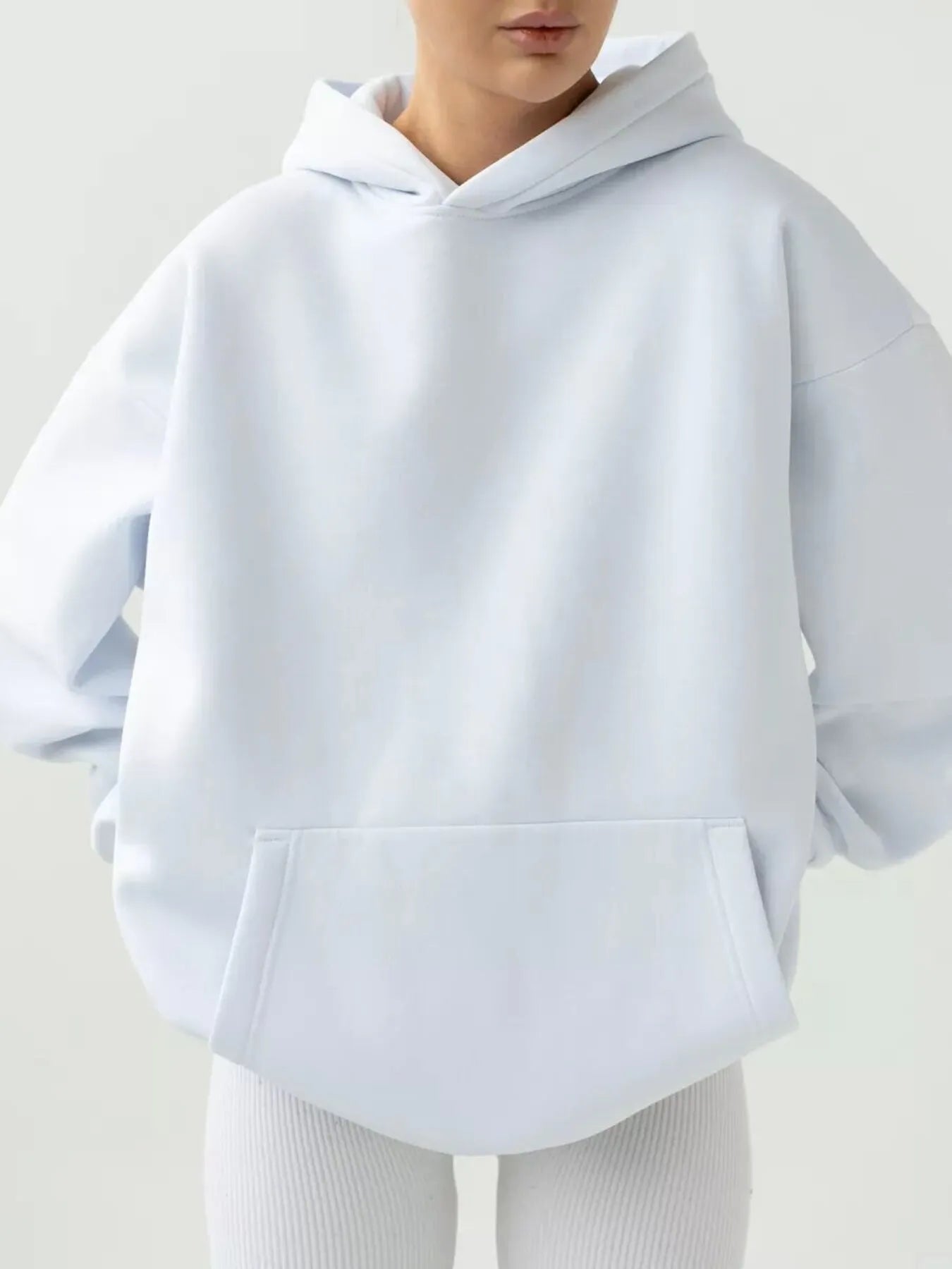 Kangaroo Pocket Long Sleeve Hoodie with soft fabric, featuring a convenient pocket and slight stretch for comfort and style.