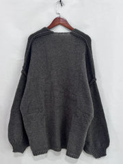 Back view of Open Front Dropped Shoulder Cardigan in gray, showcasing its oversized textured design and voluminous sleeves.