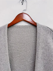 Gray oversized textured open front cardigan on wooden hanger, featuring dropped shoulders and soft-touch fabric for chic comfort.
