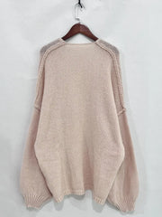 Back view of an oversized textured open front dropped shoulder cardigan in soft pink, showcasing its slouchy silhouette and luxe comfort.