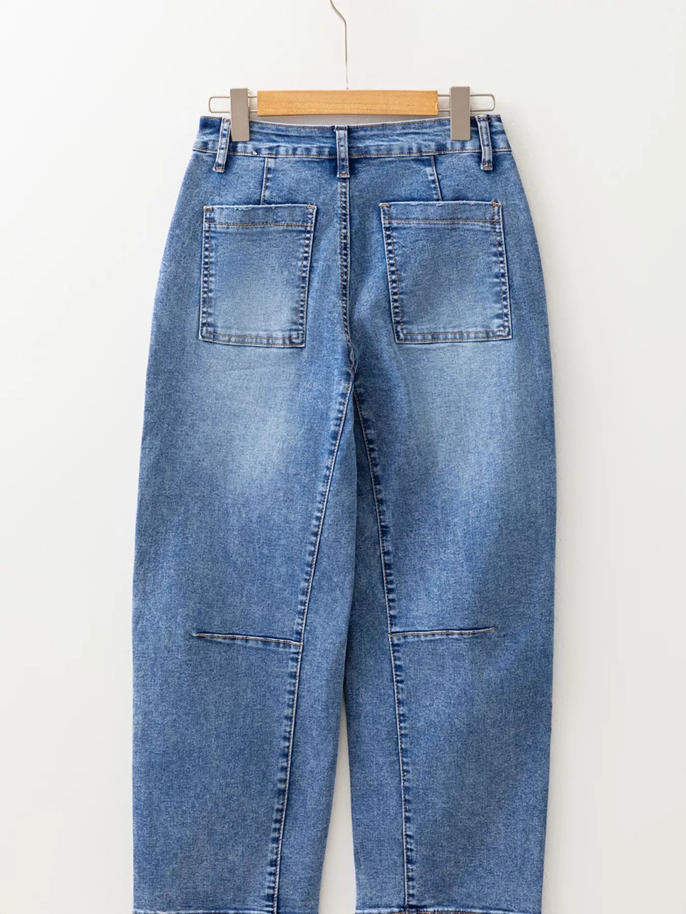 Seam Detail Loose Fit Cropped Jeans hanging, featuring subtle seam detailing and relaxed fit, perfect for modern, casual looks.