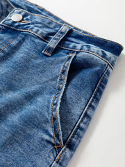 Detail view of blue denim loose fit cropped jeans with seam detailing and button closure.