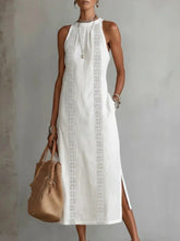 Model wearing White Side Slit Sleeveless Hollow-Out Trimmed Midi Dress with lace trim and pockets, styled with a tote bag.