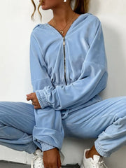 Sky blue zip up long sleeve top and pants set in soft velour fabric, featuring a relaxed hoodie and joggers with drawstring waist and pockets.
