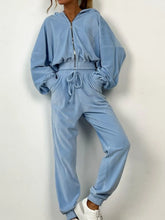 Sky blue zip-up long sleeve top and pants set with drawstring waist and white sneakers, ideal for lounging or casual outings.