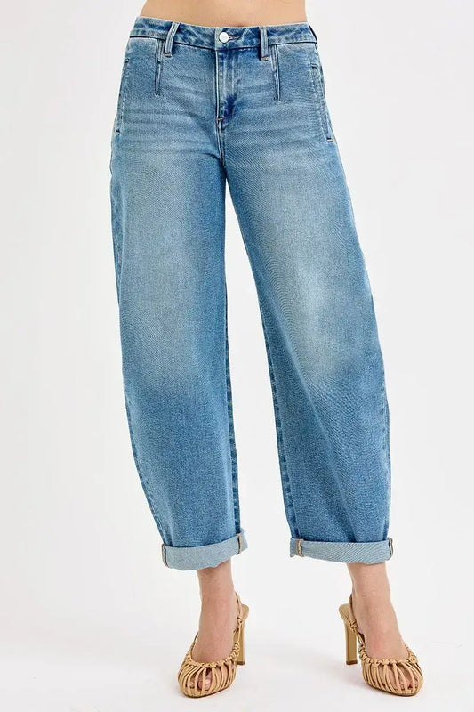 Woman wearing high-waisted wide-leg jeans and strappy heels, showcasing trendy fall fashion.