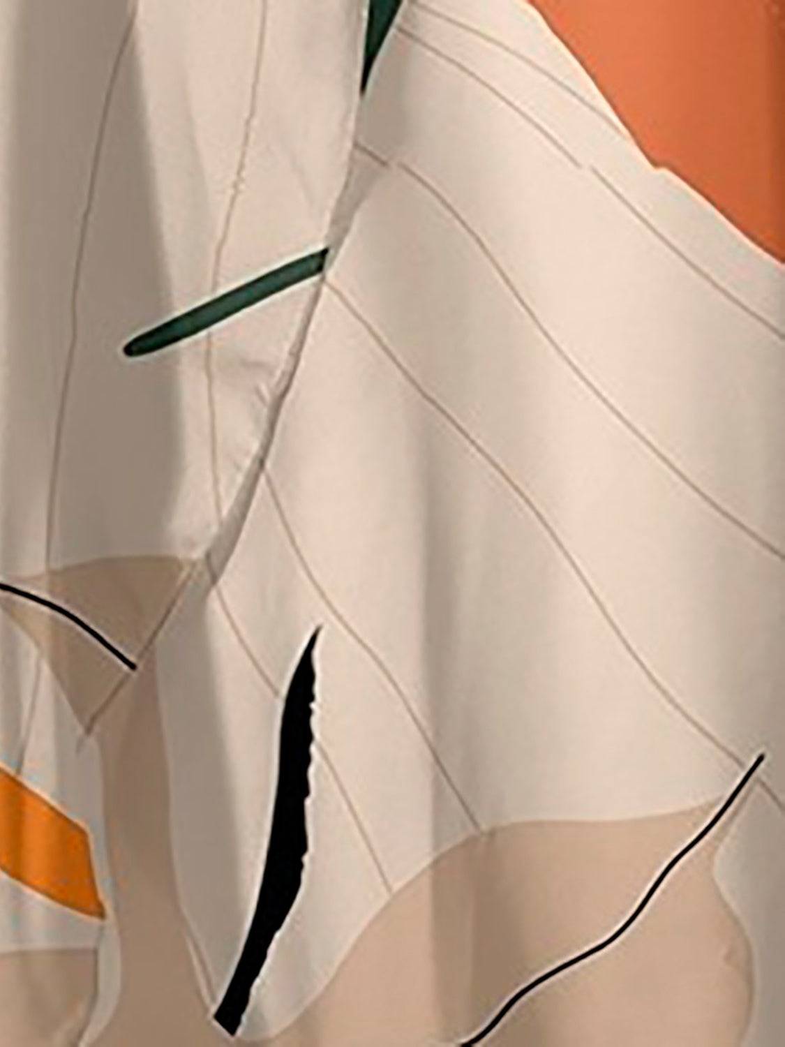 Close-up of the FAM-FAM Printed Swimwear and Skirt Set fabric highlighting the soft beige base with green, orange, and black abstract floral design.