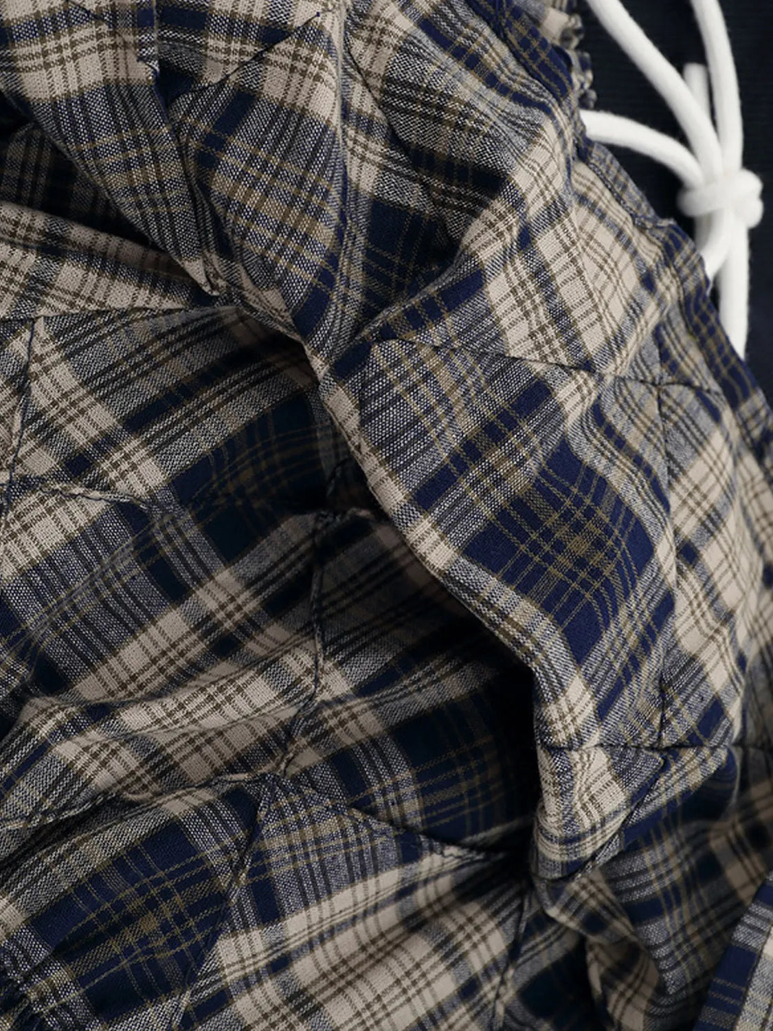 Close-up of ruched Drawstring Plaid Skort fabric texture and drawstring detail