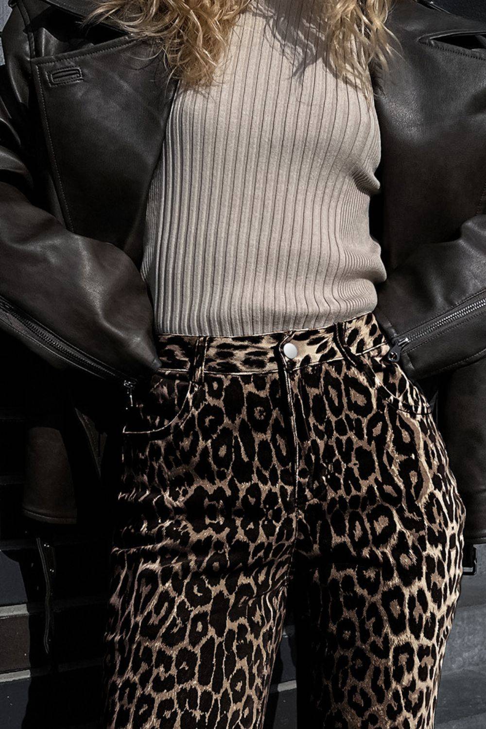 Close-up of Leopard Wide Leg Pants with Pockets paired with a ribbed top and leather jacket, showcasing texture and print details.
