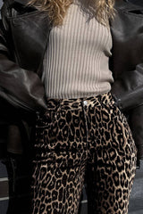 Close-up of Leopard Wide Leg Pants with Pockets paired with a ribbed top and leather jacket, showcasing texture and print details.
