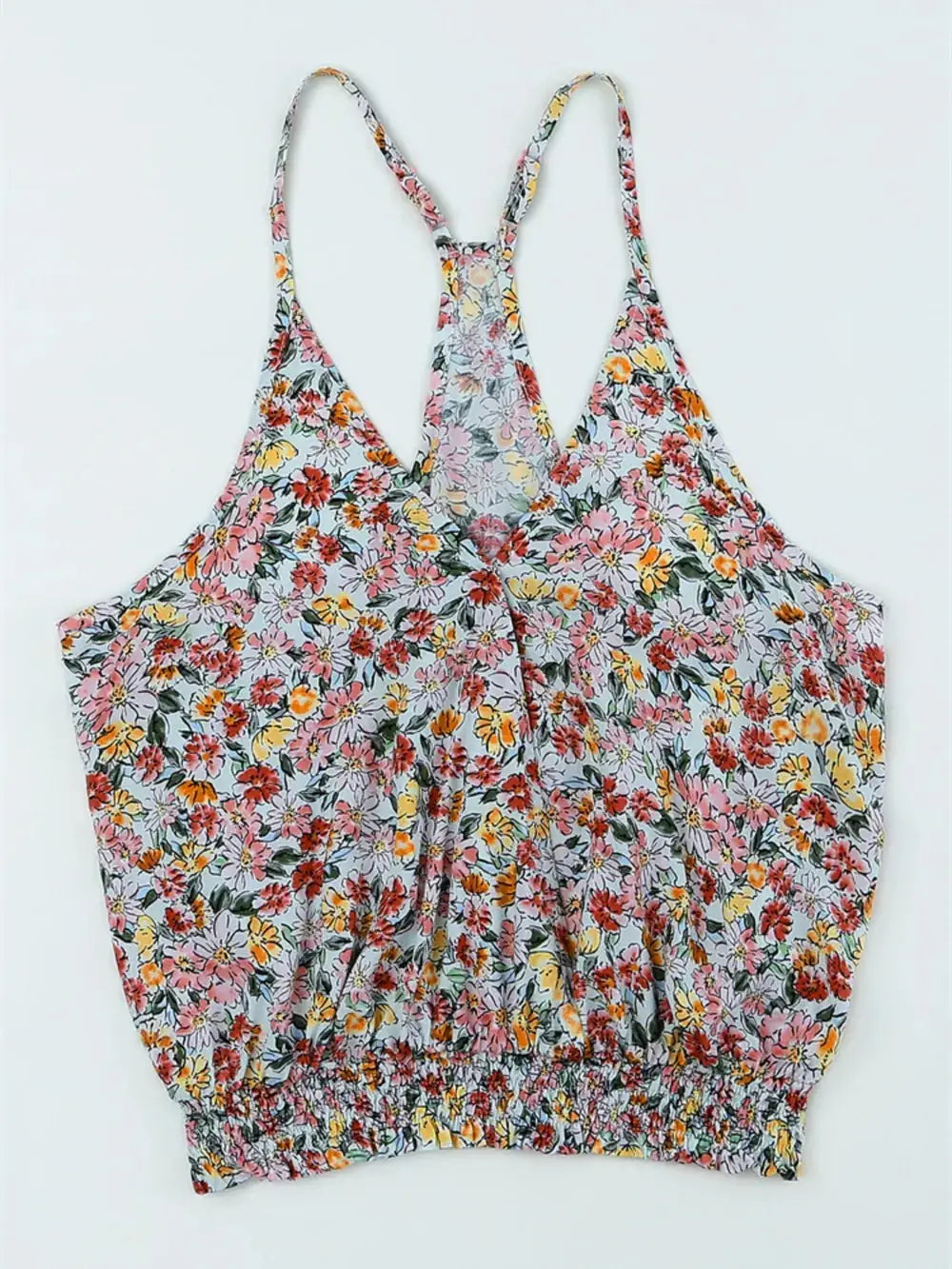 Flat lay of Floral Surplice Cami Tops & Tees GirlSavvi showing front design with colorful floral print and smocked hem detail.