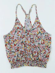 Flat lay of Floral Surplice Cami Tops & Tees GirlSavvi showing front design with colorful floral print and smocked hem detail.