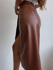 Woman wearing brown Slit Leather Midi Skirt with side slit, showcasing sleek and sophisticated style.
