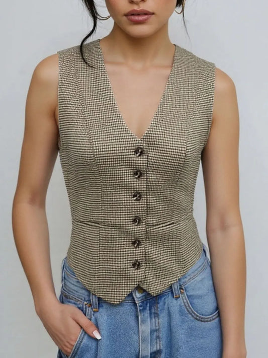 Woman wearing a plaid button down vest with lined interior and normal thickness for stylish comfort.